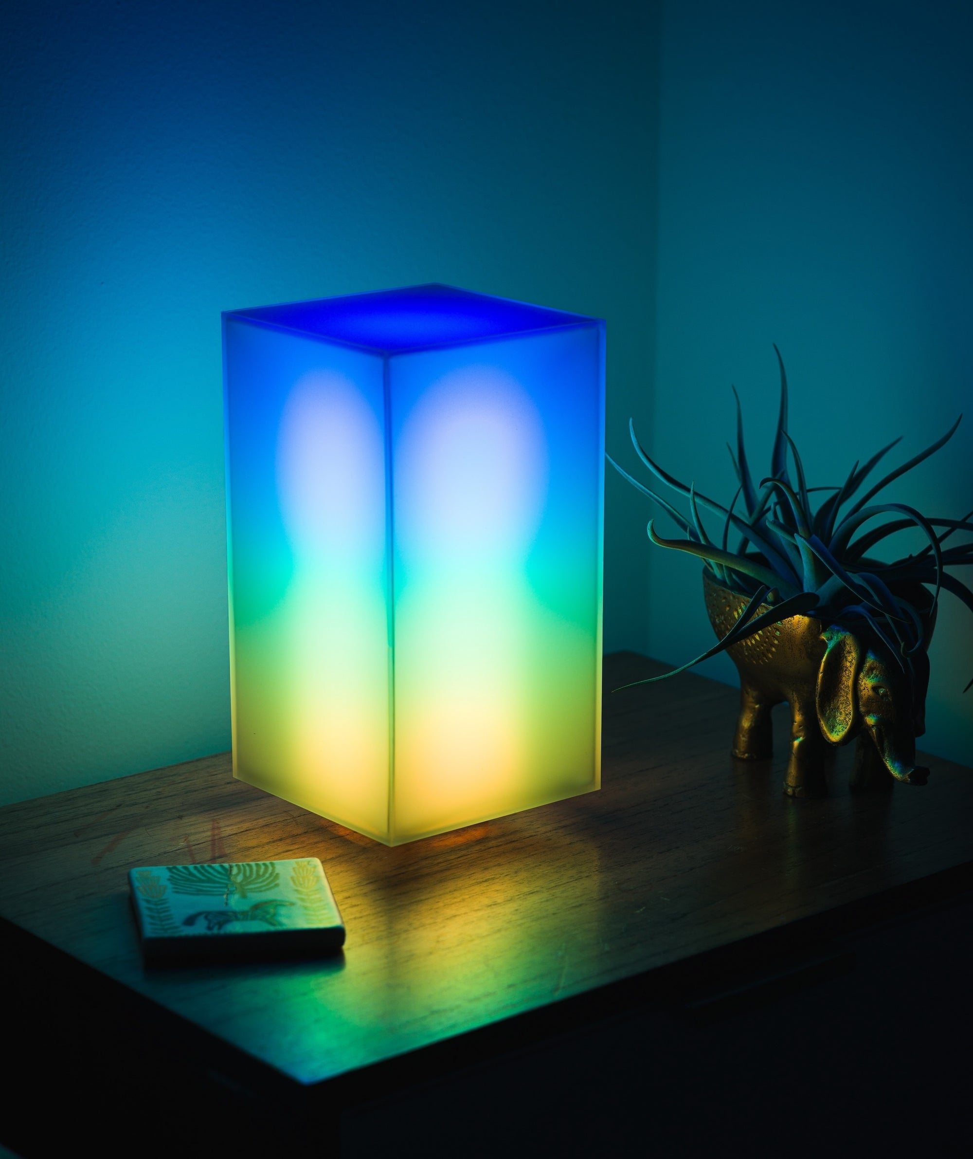 Showing off a vibrant multicolor lighting animation of Monos designer lamp in a bedroom