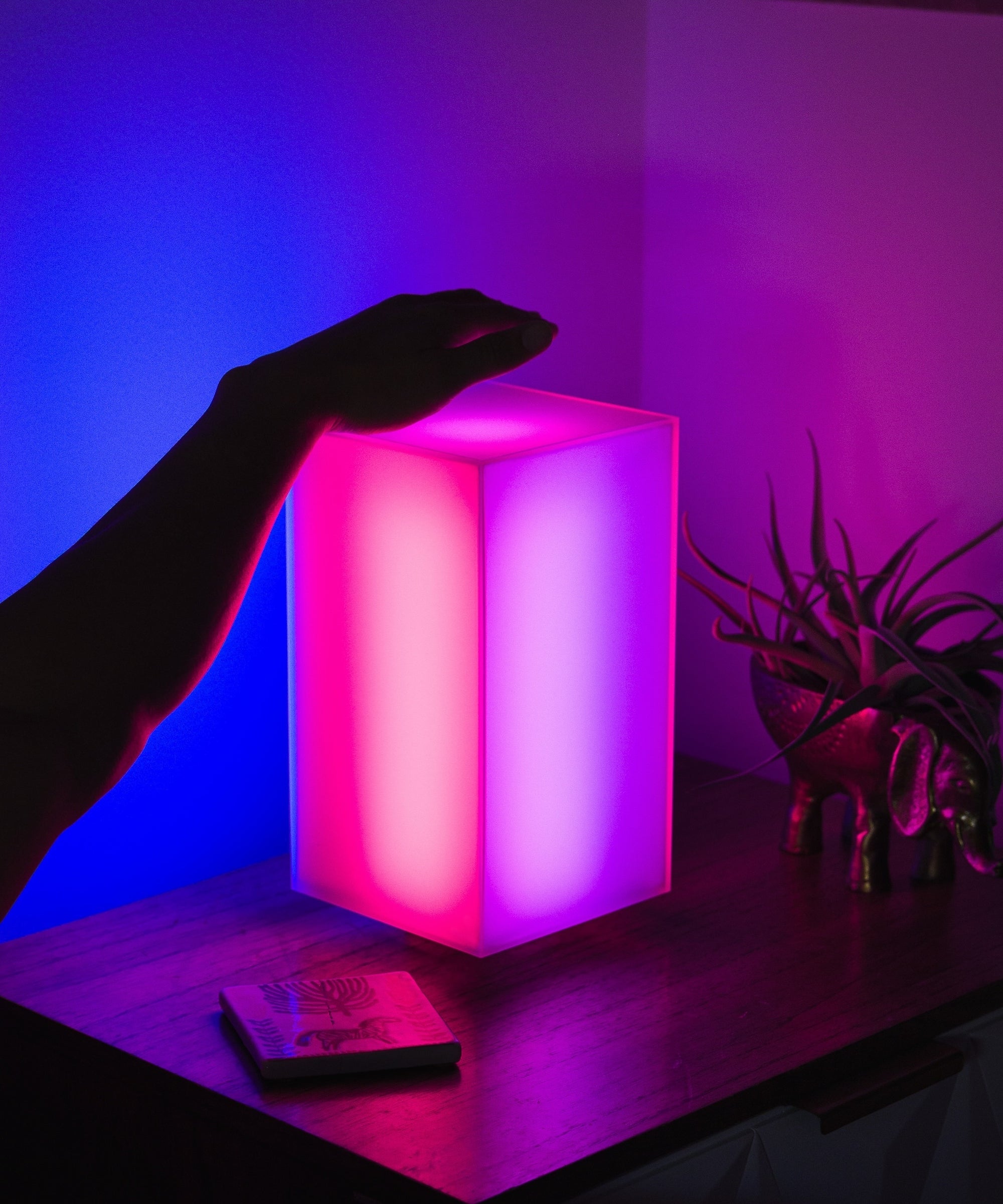 Showing off the Monos minimalist lamp in a bedroom