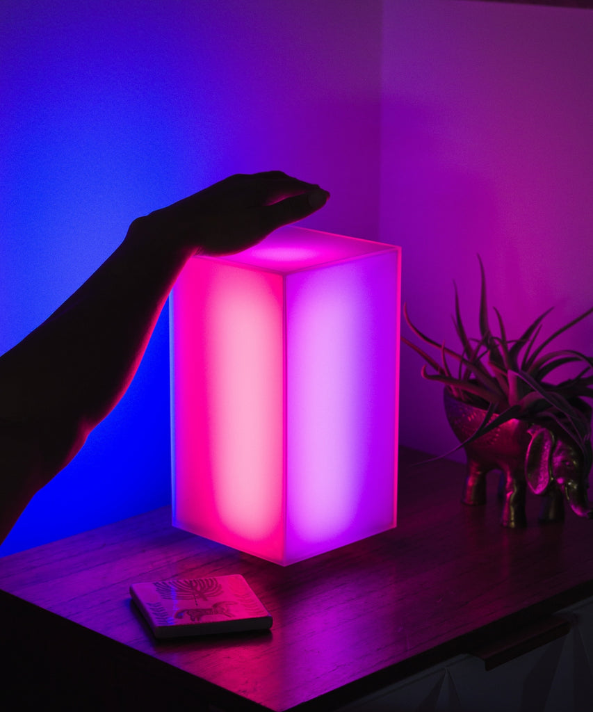 Showing off the Monos minimalist lamp in a bedroom