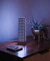 Monos minimalist lamp in a bedroom, with the removable lamp shade off