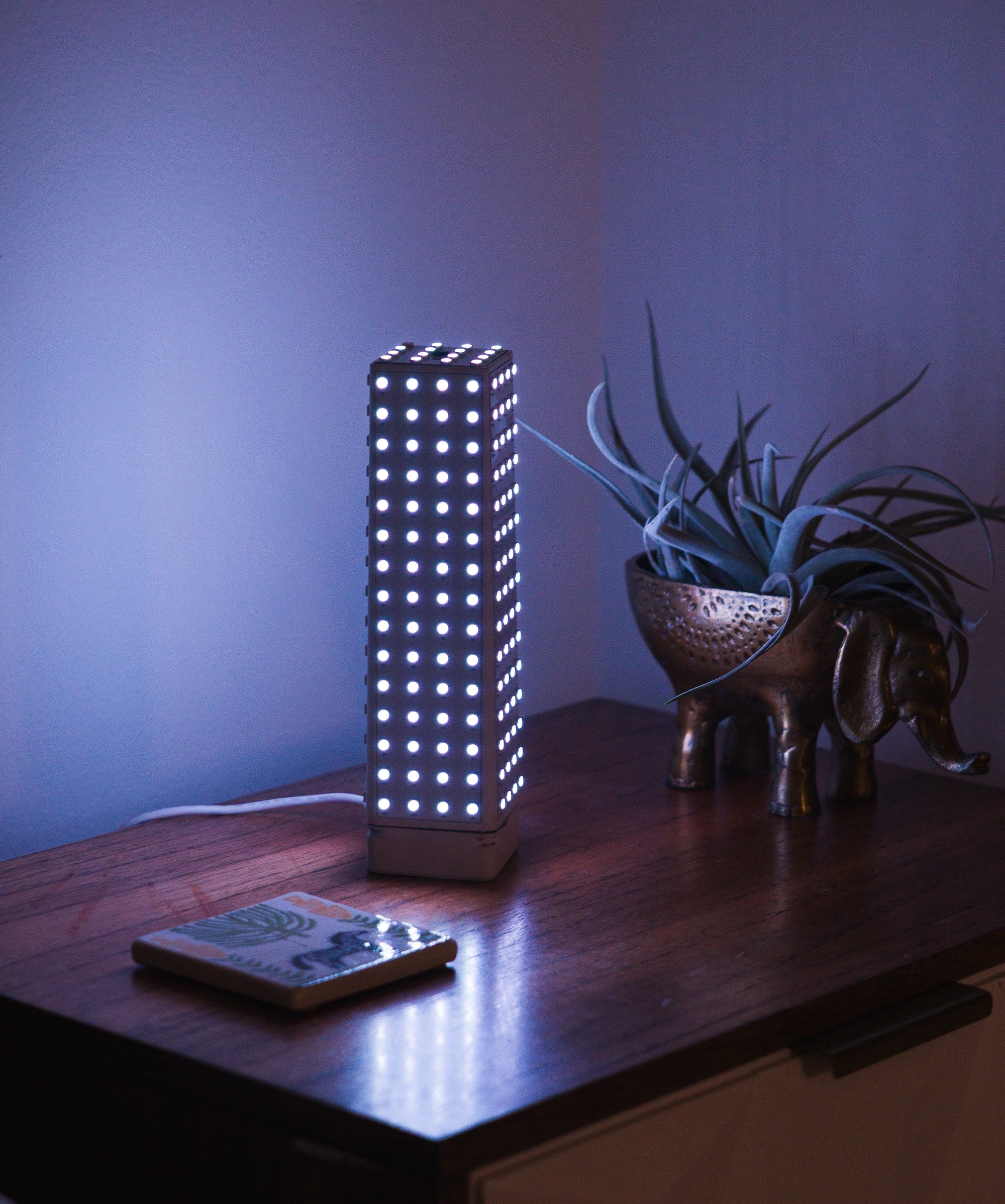 Monos minimalist lamp in a bedroom, with the removable lamp shade off